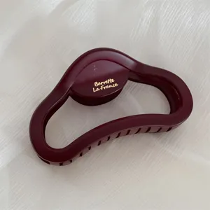 Matte burgundy hair claw detail shot, large cloud design for thick hair styling accessories.