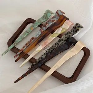 Detailed shot of stylish acetate hair sticks set in various retro tortoise shell and solid colors.