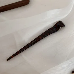 Detail shot of Chinese style tortoise-shell acetate hairpin, elegant daily hair styling accessory.