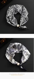 Detailansicht Seidenhalstuch für Damen mit Paisleyblumen und Perlmagnetverschluss.