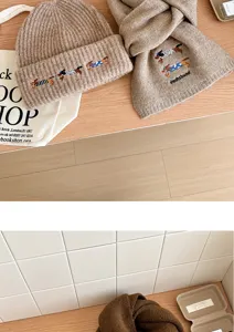 Conjunto de gorro y bufanda de invierno acogedor con detalle de bordado de salchicha para días fríos.