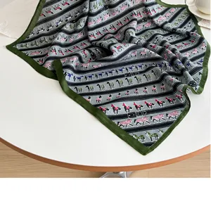 Detailed view of the green border horse pattern silk square scarf, elegant neck accessory.