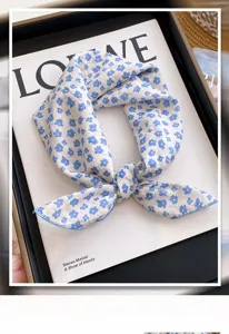 Detailed view of blue floral print small square scarf, elegant neck accessory and styling detail.