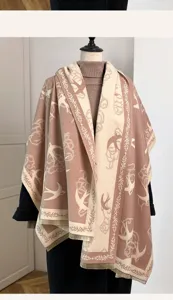Detailed view of double-sided knit shawl featuring elegant swallow patterns and tassel fringe.