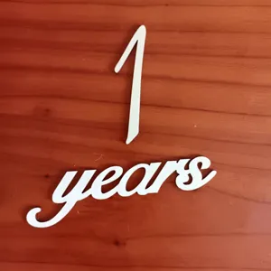 White wooden 1 year milestone cutout prop for newborn baby photography and monthly records.