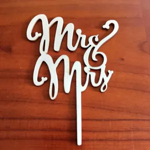 Wooden Mr and Mrs cake topper detail shot, rustic wedding dessert decoration prop display.