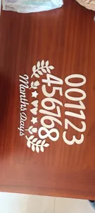 Wooden baby monthly milestone number sign set with decorative shapes for photography props.