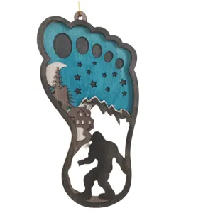 Wooden Bigfoot footprint hanging ornament with 3D forest cabin silhouette design for decor.