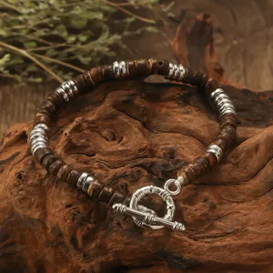 Handmade bohemian style coconut shell and metal bead bracelet with toggle clasp for unisex.