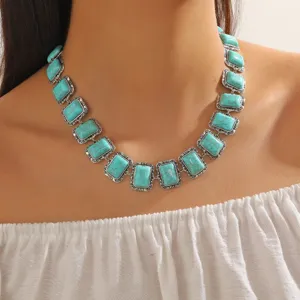 Close-up detail of the bohemian vintage turquoise geometric rectangular necklace on model.