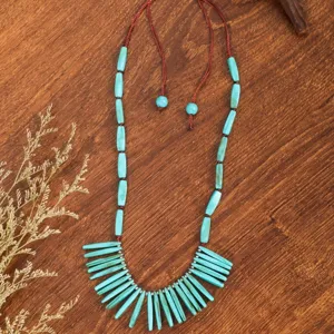 Boho turquoise beaded necklace detail, ethnic handmade gemstone pendant for women.