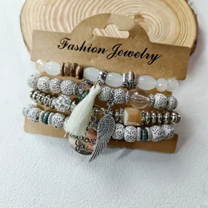 Boho multi-layer beaded bracelet set with tassel and wing charm for women vintage chic.