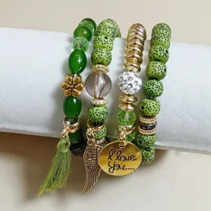 Multi-layer bohemian beaded bracelet detail with green stones, charms, and tassel accents.