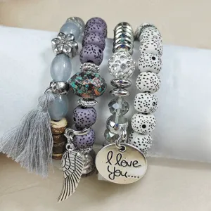 Bohemian multi-layer beaded elastic bracelet set with tassel and metal charm pendants.