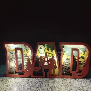 Wooden DAD carved night light desktop ornament with multi-layer hollow forest silhouette design.