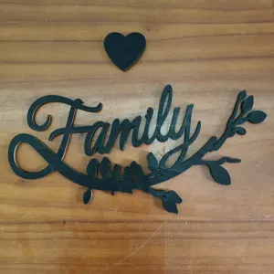Wooden Family wall decor detail view featuring black cutout letters birds and heart sign.