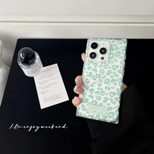 Detailed shot of trendy green leopard print phone case, square glossy transparent design.