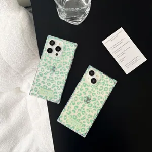 Detail view of transparent square glossy phone case with green leopard print design.