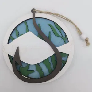 Close-up detail of wooden hollow ocean fish hanging ornament with hemp rope and blue sea.