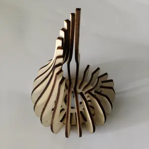 Wooden laser cut tealight candle holder detail, spiral lotus shape home decor piece.