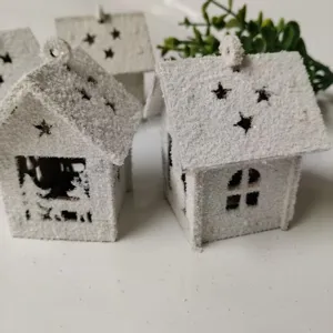 Wooden Christmas snow-flocked miniature house ornament with star cutouts for holiday decor