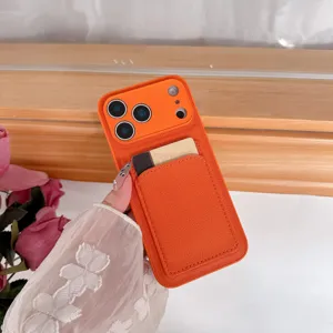Orange leather iPhone case with card holder pocket, detailed view of back design and texture.