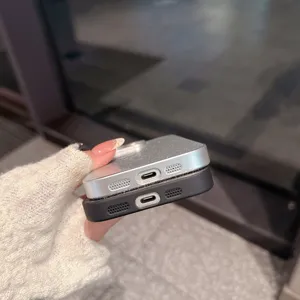 Detailed view of sparkly silver and black phone protective cases showing bottom port cutouts.