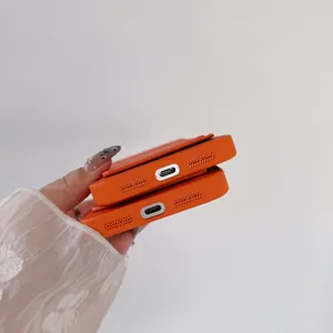 Detail shot of orange leather phone case with cardholder slot and precise bottom cutouts.