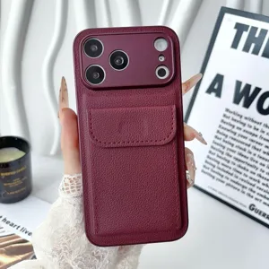 Detailed view of maroon leather phone case with back card slot, showing texture and design.