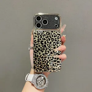 Close-up of luxury rhinestone leopard print phone case with sparkling studded camera protection.