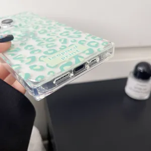 Green leopard print transparent phone case detail, square glossy design for iPhone.