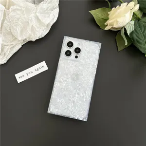 Detail shot of a square iridescent mother of pearl iPhone case with floral decor backdrop.