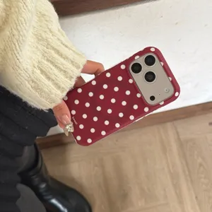 Detailed close-up view of the red and white polka dot matte phone case showing texture and design.