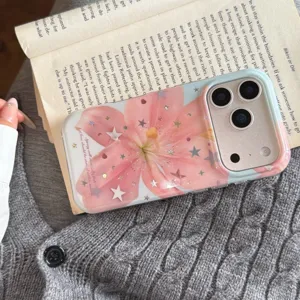 Closeup detail of aesthetic pink lily flower phone case with shiny stars and English quote print.