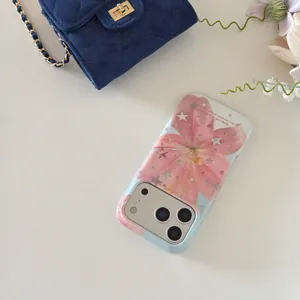 Detailed view of pink lily flower and star glitter phone case for iPhone, aesthetic design.