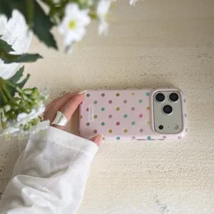 Charming pink polka dot phone case detail view, featuring colorful foil dots and sleek rounded edges.