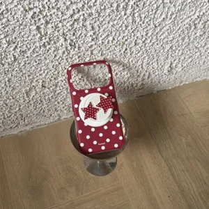 Red polka dot phone case with star grip holder, stylish protective cover for mobile phone.