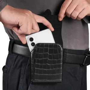 Detailed shot of a black crocodile pattern leather phone holster worn on belt with mobile.