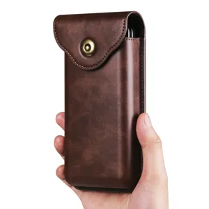 Close-up detail of the brown leather vertical phone holster with metallic snap button.