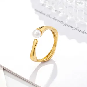 Bague ouverte dorée minimaliste dotée d'une perle blanche et d'un design en bambou.
