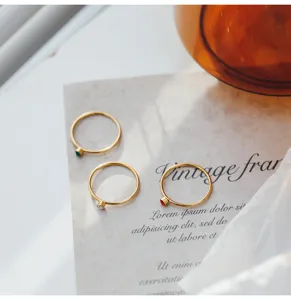 Conjunto de anillos minimalistas de acero de titanio chapado en oro con zircones vista detalle.