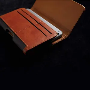 Close-up of brown leather phone holster with card slots and magnetic closure detail.