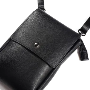 Detailed view of the black vertical leather crossbody phone bag showcasing texture and strap.