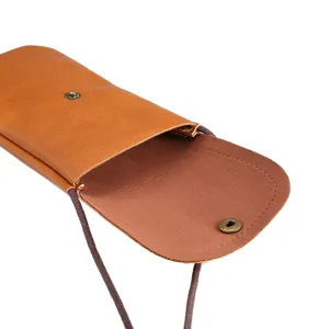 Brown leather vertical phone pouch detail view with strap and metal snap button closure.