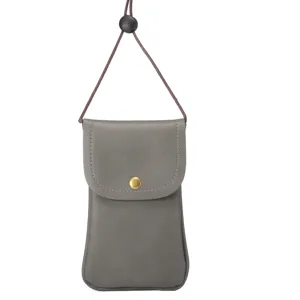 Grey cowhide texture vertical crossbody phone bag detail view, flip cover with brass snap button.