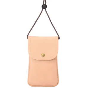 Detail of vertical phone crossbody bag, pink leather texture pouch with brown lanyard.