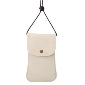 Close-up detail of beige leather crossbody phone pouch with brown lanyard and snap button.