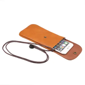 Detail of brown leather vertical crossbody phone bag with adjustable cord and snap button.