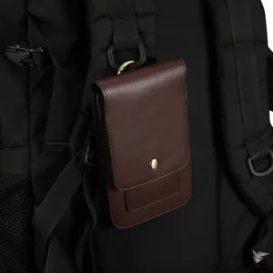 Brown leather phone waist pouch detail shot, hanging on black backpack, premium texture.