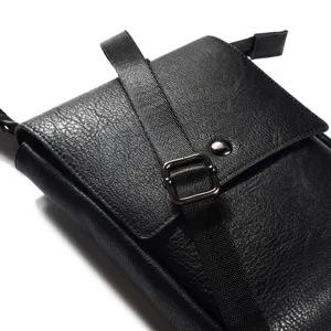 Detailed view of black vertical leather phone pouch showcasing texture and metal buckle.
